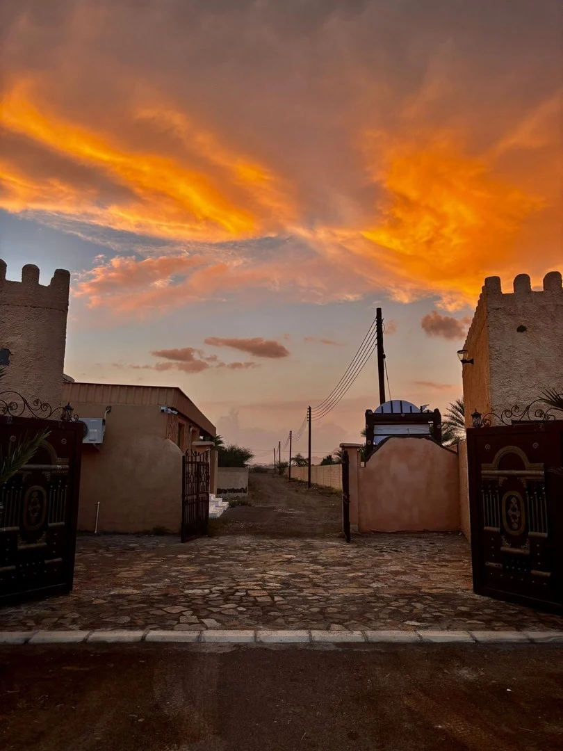 The Fort gate under an evening sky